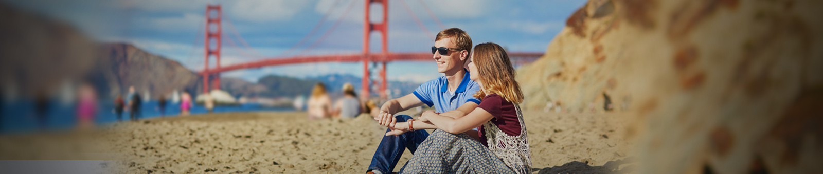 two people sitting on a beach